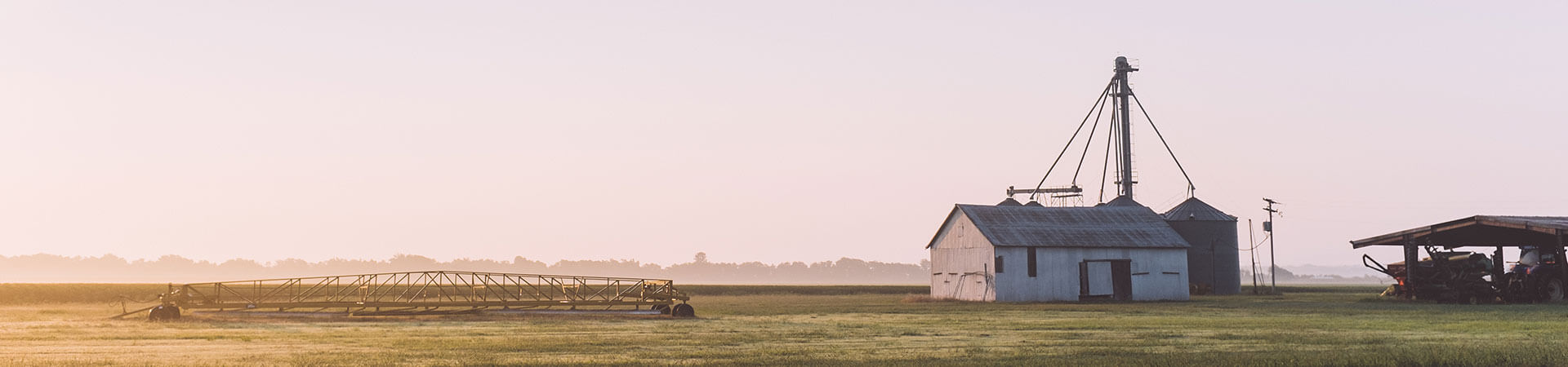 farm building and machines early in the morning